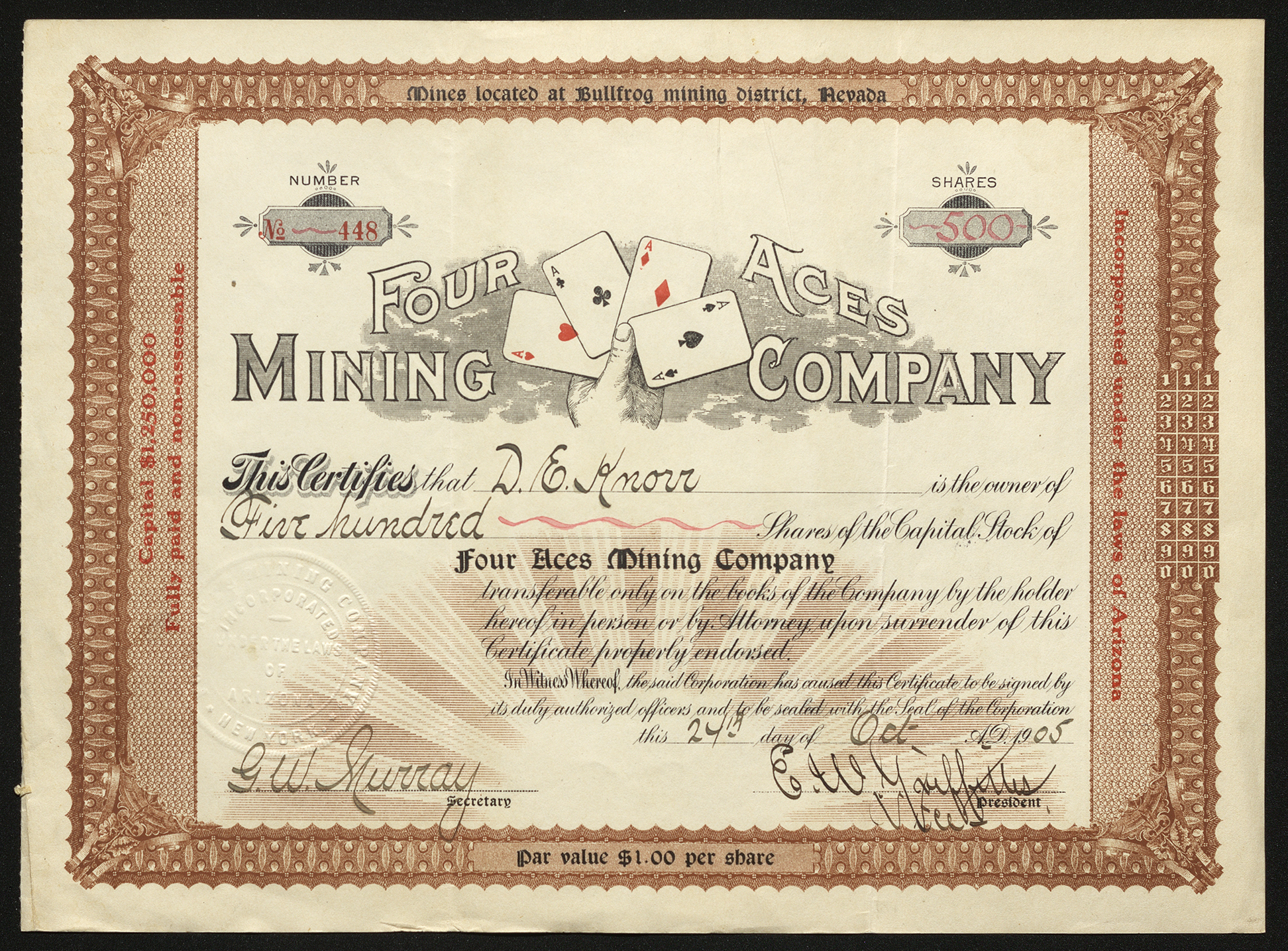 Certificate with black and red ink shows intricate bordering, lettering, signatures, company seal, and vignette of a hand holding a set of aces